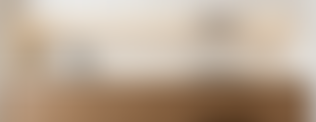 I-shaped built-in condo kitchen in light tones with under-cabinet LED and stone countertop