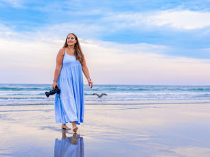 Professional photographer walking with camera in hand on the beach