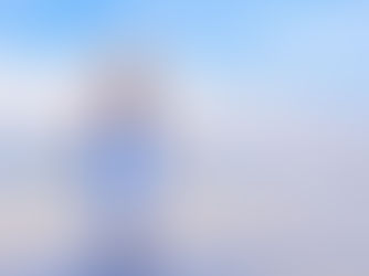 Professional photographer walking with camera in hand on the beach