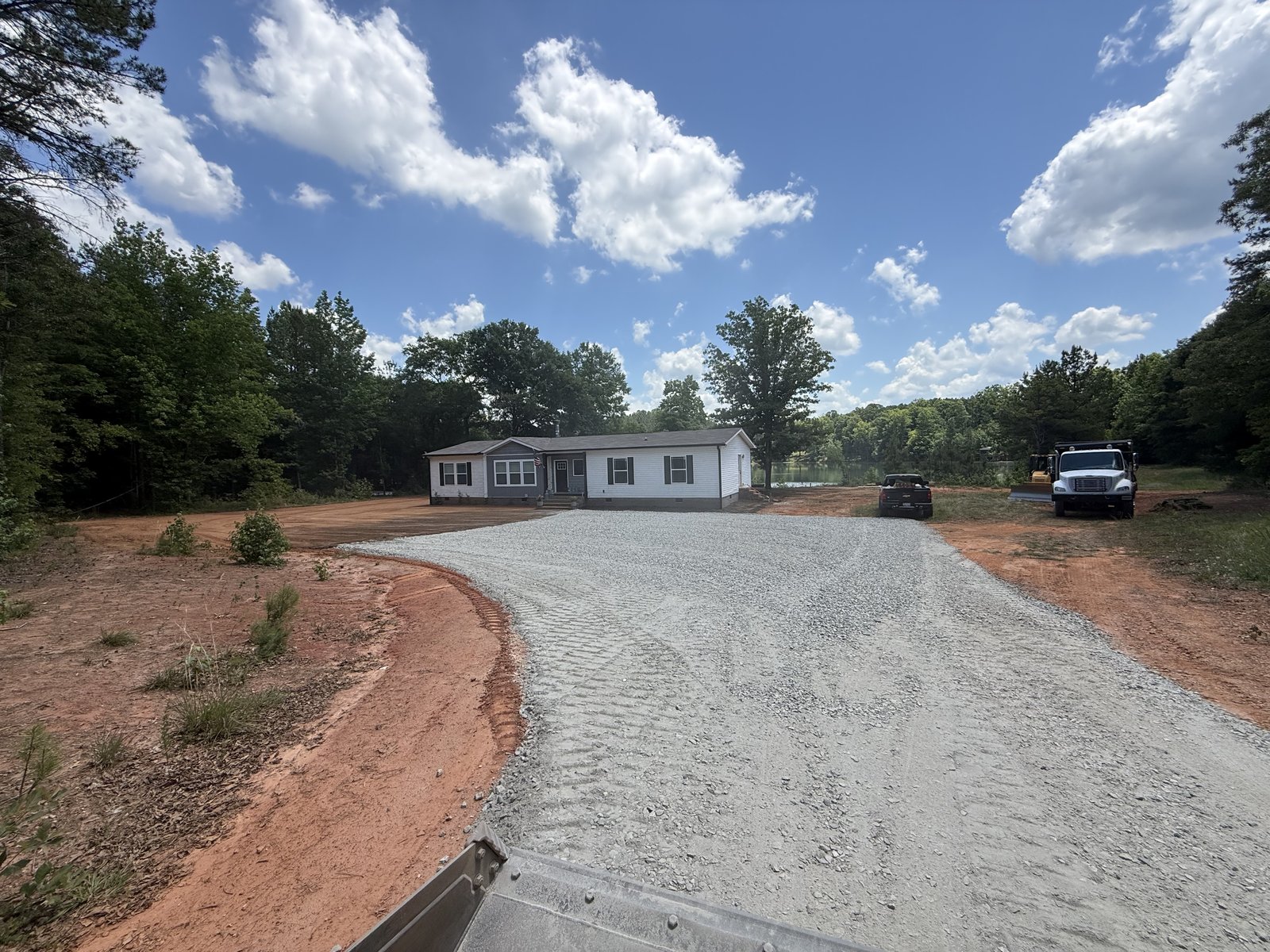 New home with gravel driveway installed by McCrone Excavating