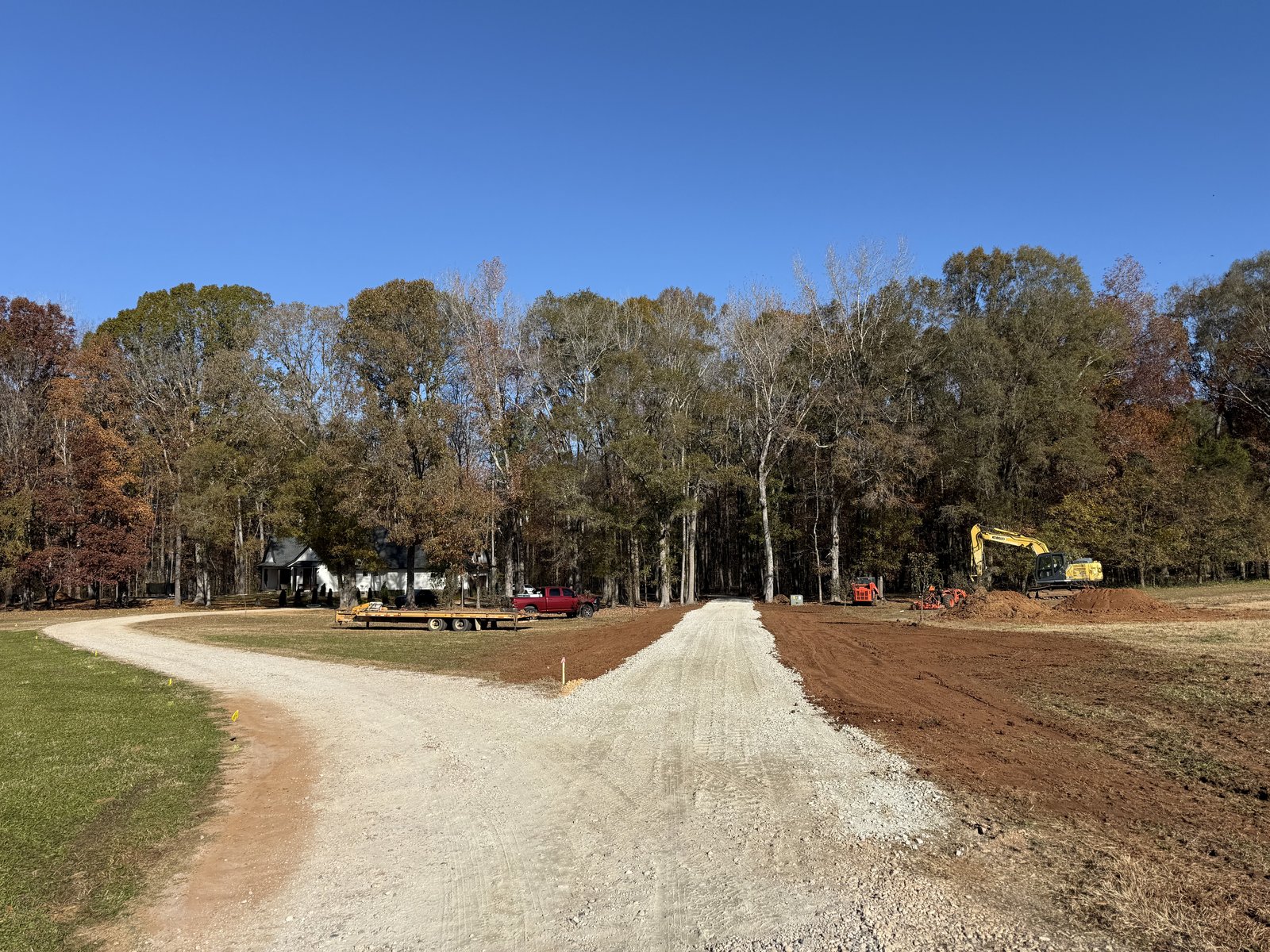 New gravel drive cut through a wooded lot