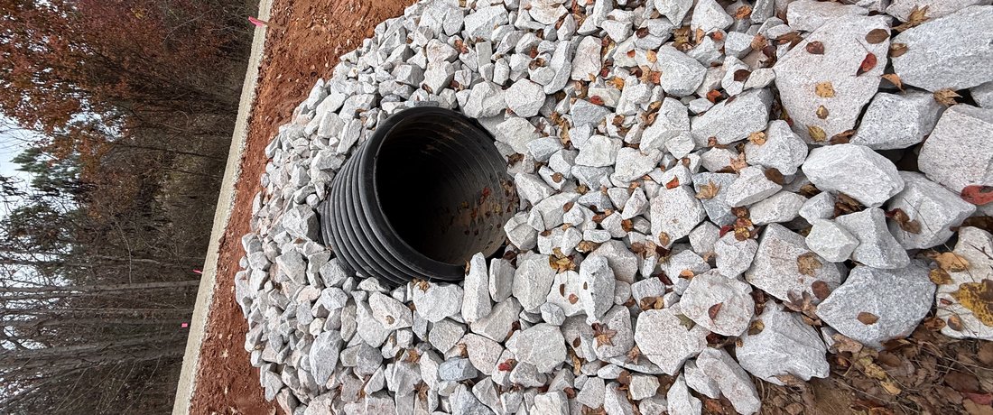 Drainage culvert with rip rap installed to fix lot drainage issues