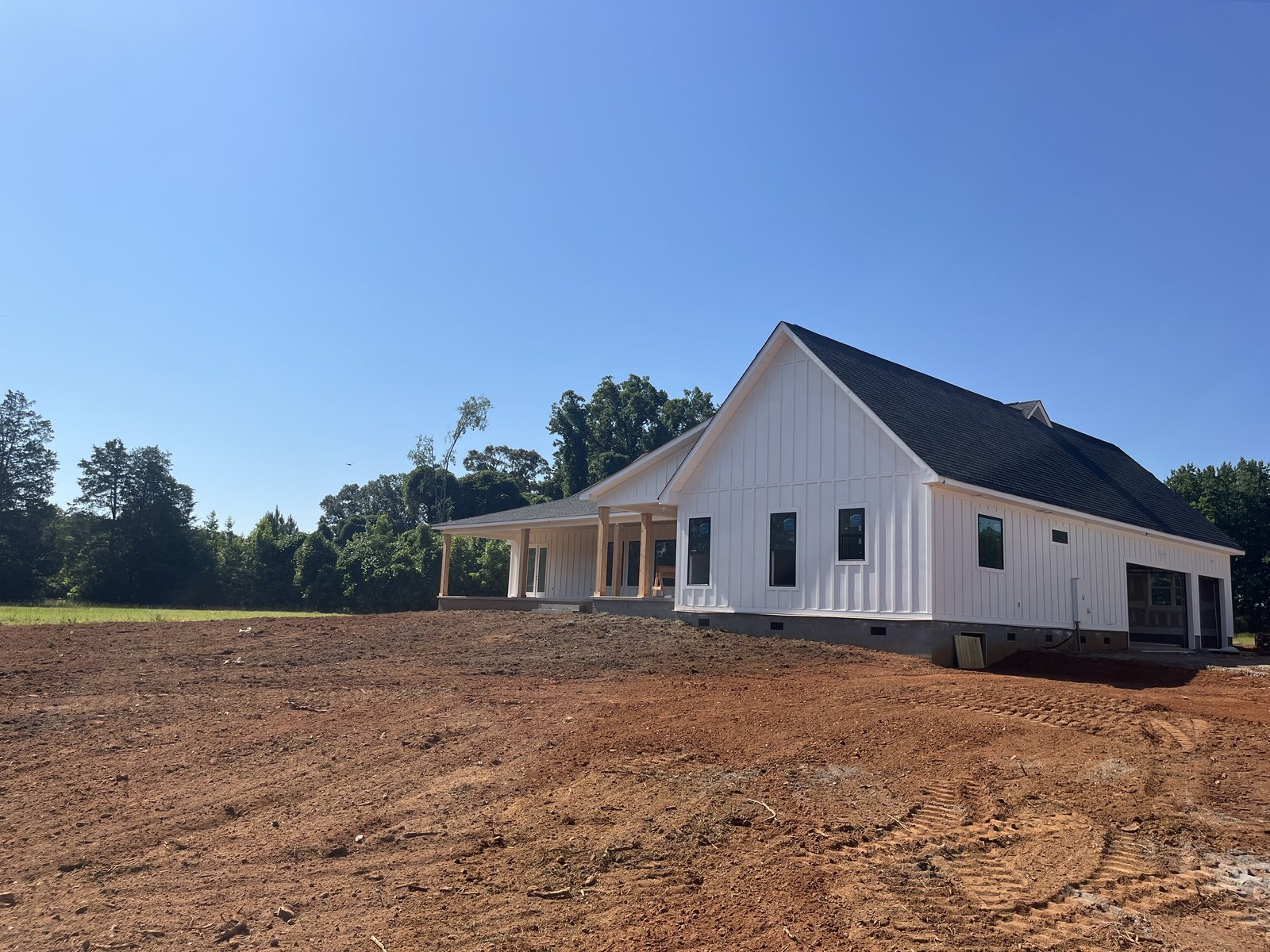 Finish graded lot around a completed farmhouse