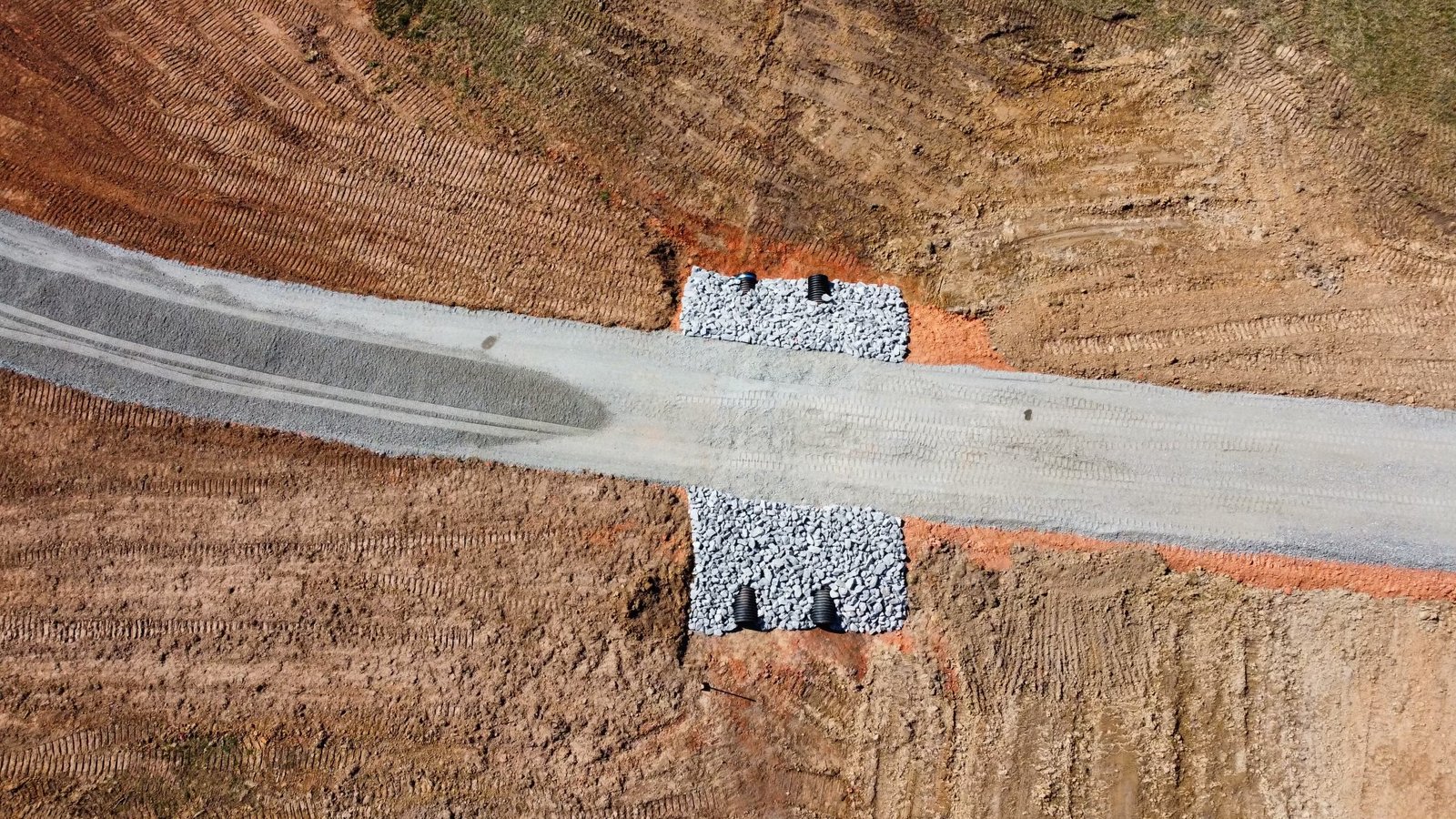 Aerial drone view of finished graded road and building site