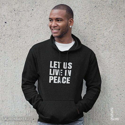 man-wearing-black-hoodie-leaning-on-concrete-wall.png