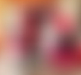 Pink and black balloon arch with floral accents and monochrome backdrop.