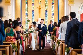 Bride and groom walk down the aisle of Corpus Christi in Oxford together