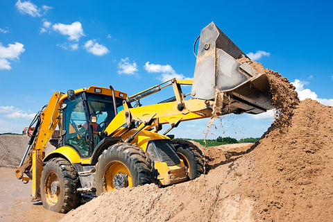 Wheel loader Excavator unloading sand with water during earth moving works at construction