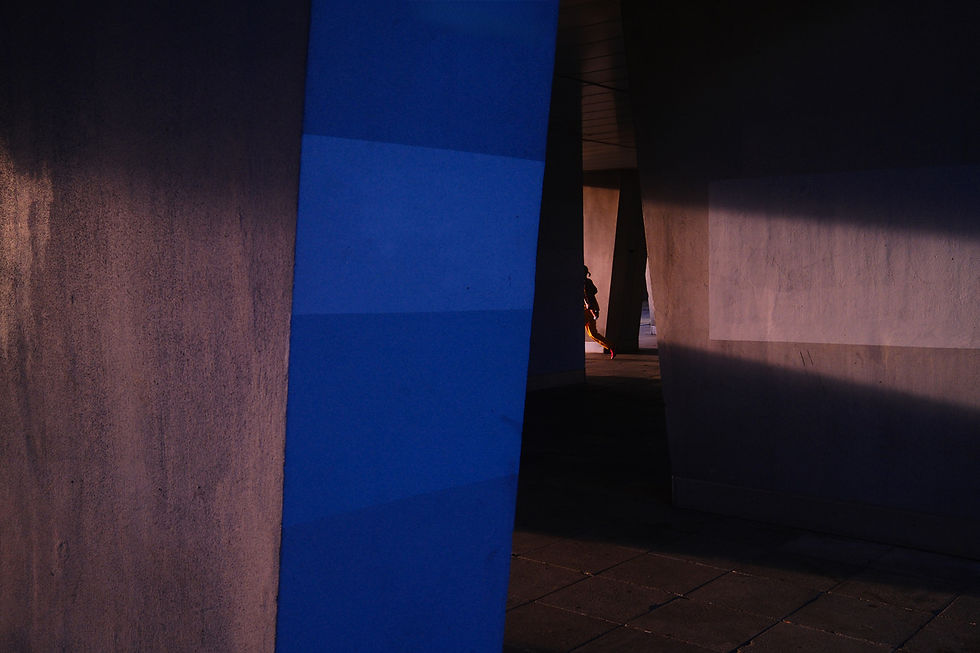 Ein blauer Balken im Vordergrund, weiter hinten ist ein gehender Mensch erkennbar.