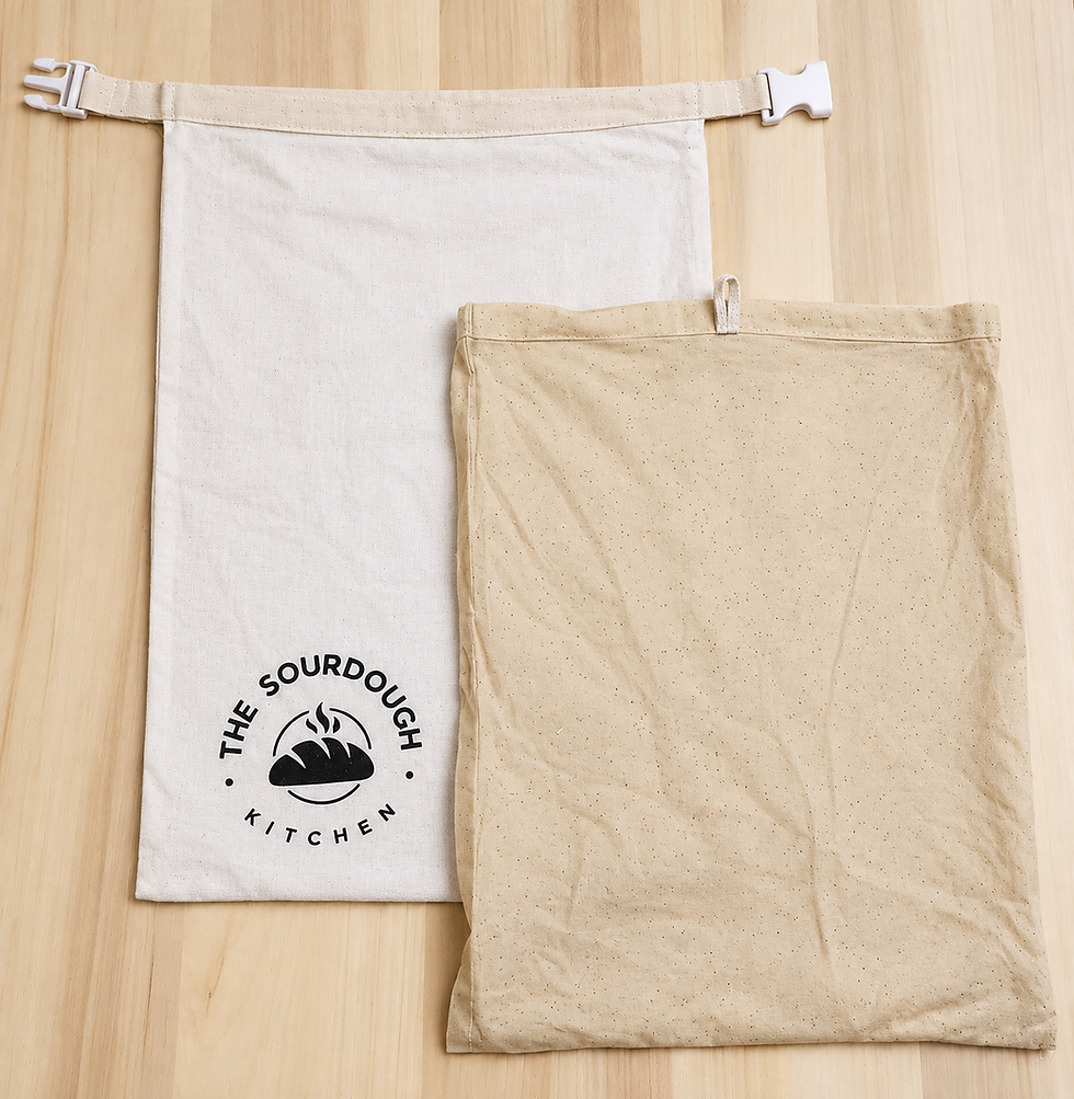 Cotton-linen bread bag with clip closure and removable beeswax liner laid out on a wooden table.