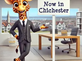 Cartoon giraffe in a suit points at a sign reading "Now in Chichester." Office setting with a city view, wooden desk, and chairs.