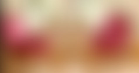 Two empty chairs facing each other in a softly lit room, with a small table and glasses of water between them — symbolising a calm, welcoming space for connection and emotional support.