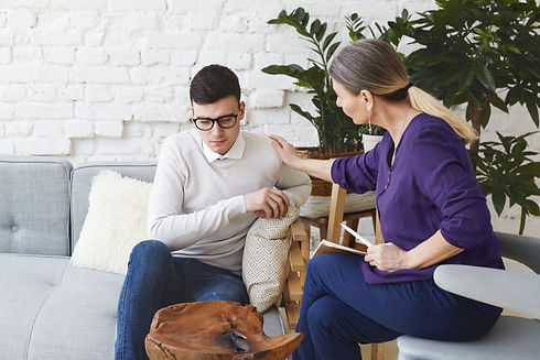 candid-shot-casually-dressed-professional-woman-psychotherapist-her-fifties-touching-her-y