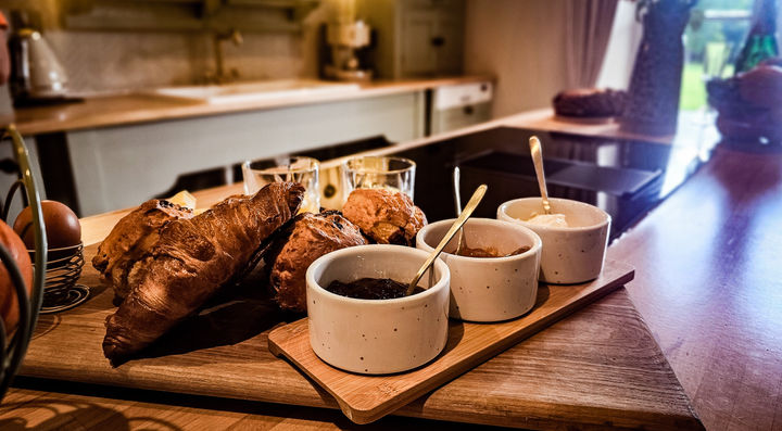Fresh breakfast spread of croissants, fruit and preserves in the country kitchen at Parsonstown Estate luxury accommodation.
