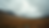Wide angle view of a scenic Scottish landscape with rolling hills and a cloudy sky