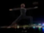 A spectacular drone show by Alo Yoga over Hong Kong's Victoria Harbour, forming a giant illuminated yoga posture and the brand logo against the night sky and city skyline