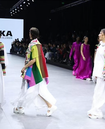Models walking the runway at Alemika fashion show, featuring vibrant and eclectic designs
