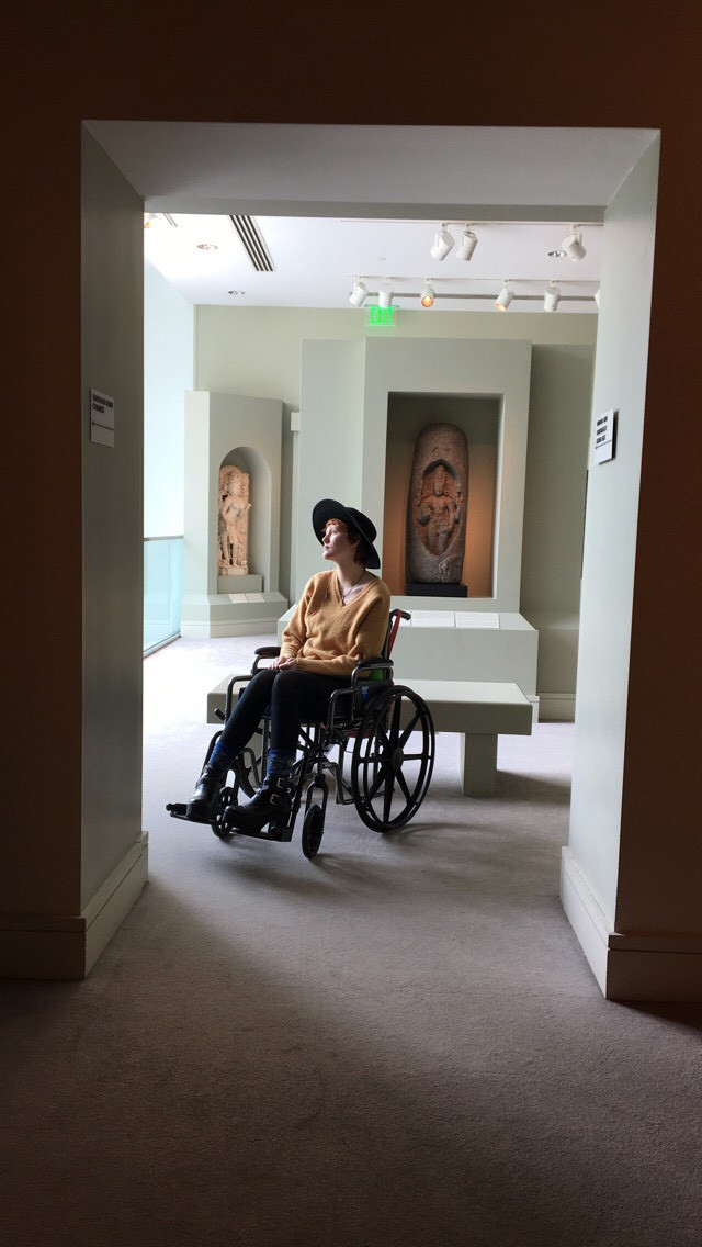 girl with chronic illness in wheelchair in front of mirror