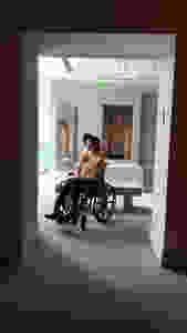 girl with chronic illness in wheelchair in front of mirror