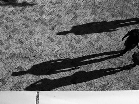 Shadow figures on pavement representing covert narcissist vs overt narcissist dynamics and the hidden nature of narcissism.
