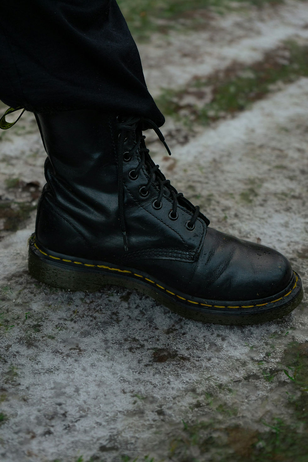 Close-up of black lace-up boots being worn