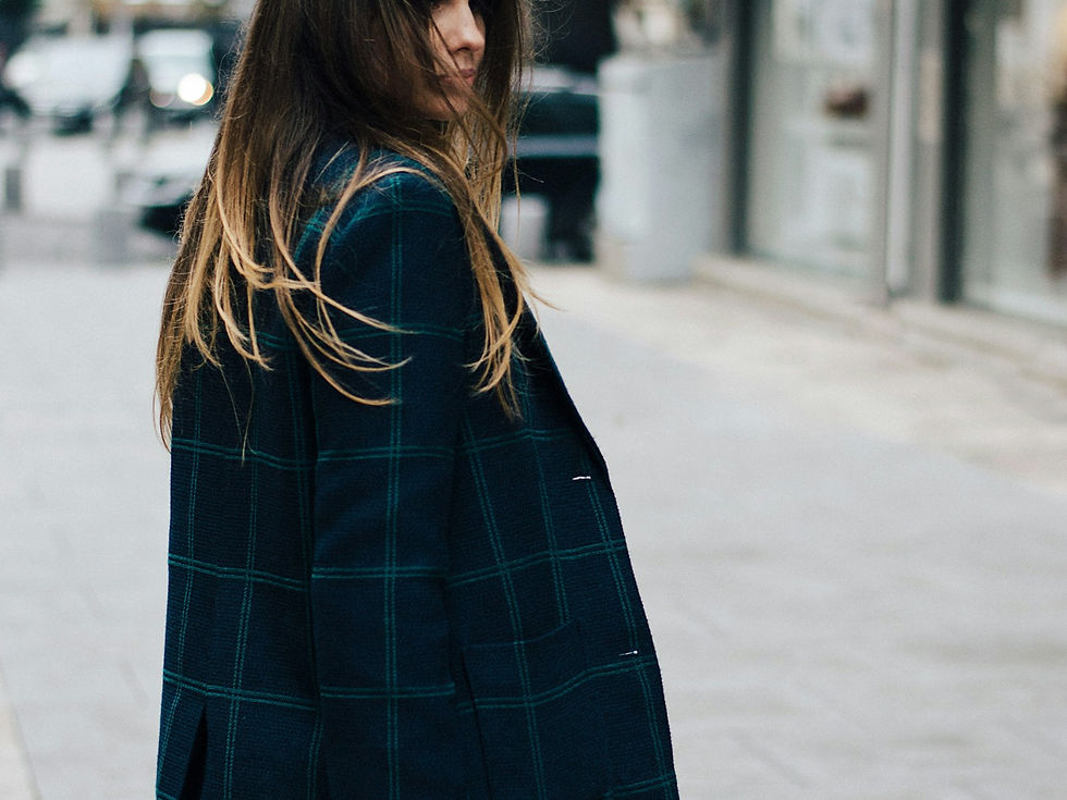 Woman in a dark wool coat on the street, shoulder seam visible
