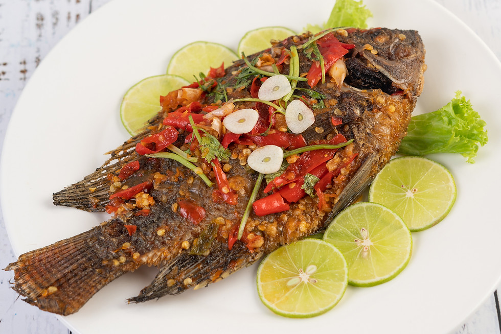fried-tilapia-with-chili-sauce-lemon-salad-garlic-plate-white-wooden-table.jpg