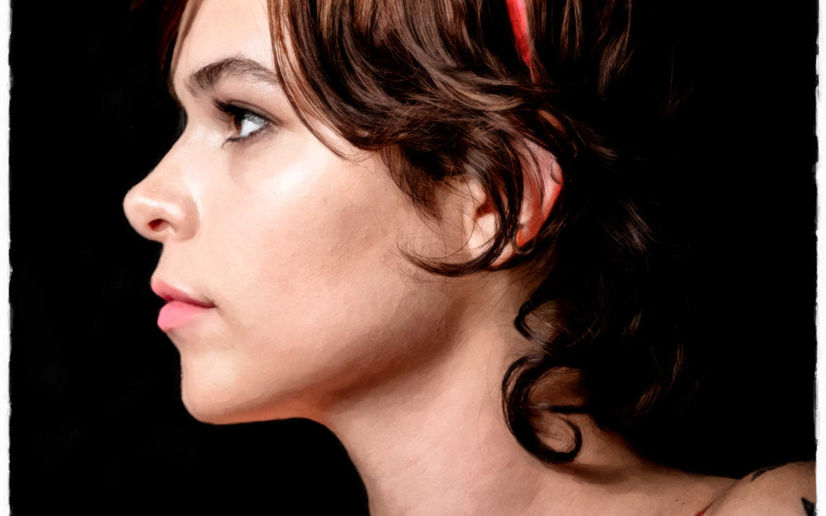 a portrait of a dark haired lady in profile against a black background.