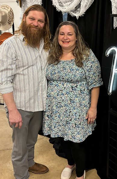 Cora and Justin, owners of Kadash Ltd., holding personalized engraved products.