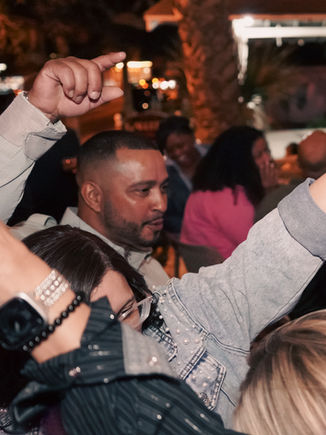 Lively indoor gathering at Jefe Cigar Lounge's karaoke night in New Smyrna Beach, Florida. Guests dance and enjoy drinks in a vibrant atmosphere