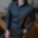 Man in a premium dark dress shirt with structured shoulders