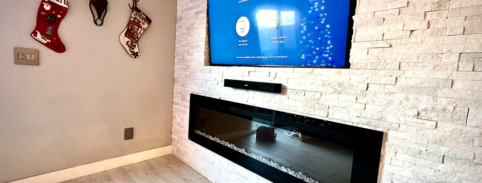 TV installed on a recessed wall niche surrounded by stone in a Las Vegas NV home, leveled and securely mounted for a clean built-in look.