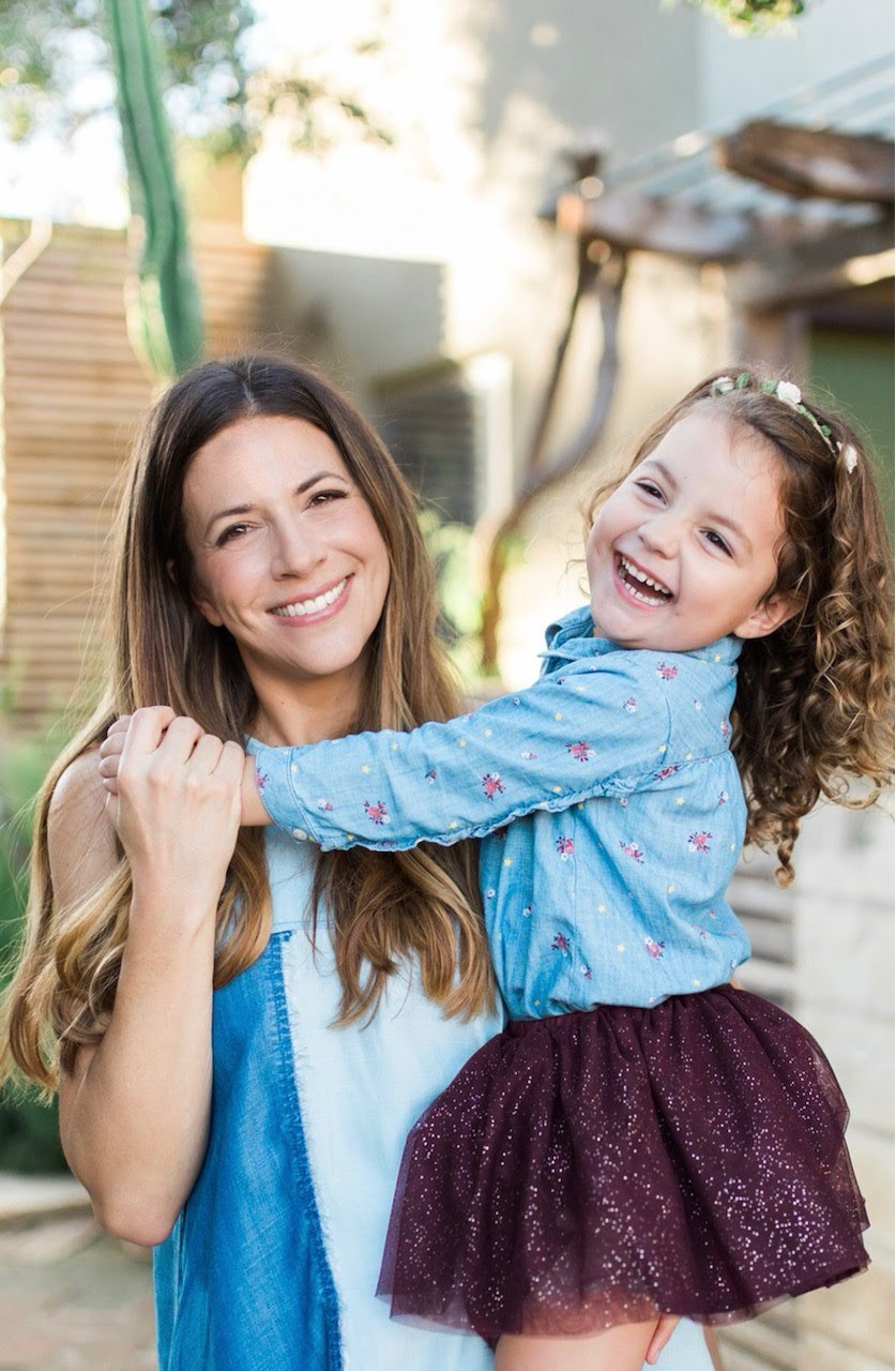 Dr. Katie Keller, holding a child.