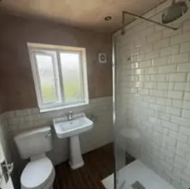 Bathroom with metro tiling, pedestal basin and walk-in shower