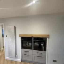 Built-in oven housing with timber beam detail and vertical radiator