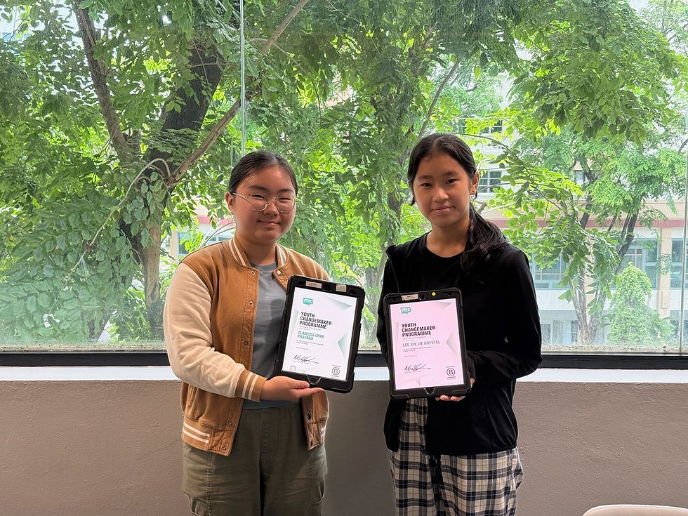 Two people smiling, holding certificates on tablets indoors. Background shows trees through a large window, creating a fresh, bright mood.