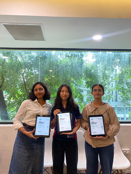 Three girls holding iPads