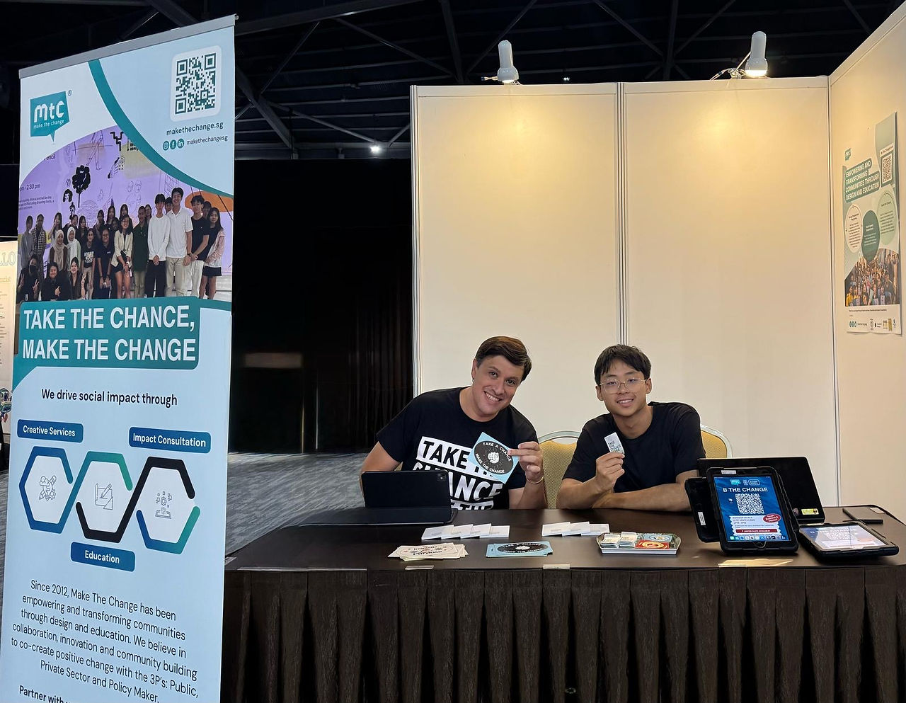 Two males handling a booth about Make The Change