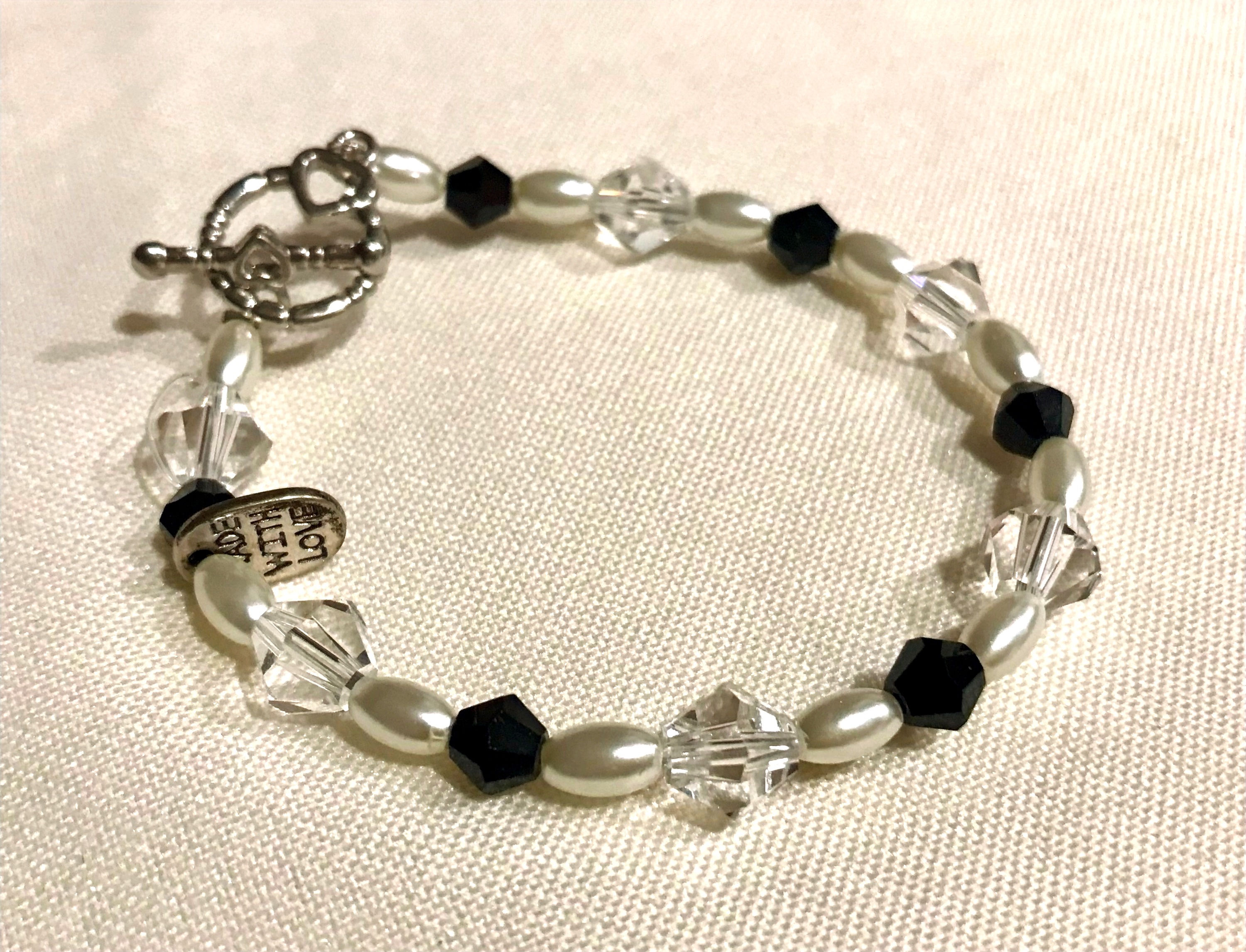 Item #501 –  Single strand with unique clear & black, crystal and faux pearl bea