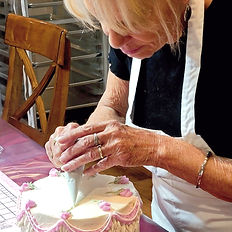 Basic cake decorating 101 students, decorating class cake with buttercream at Kathleen Lange's Confectionary Chalet