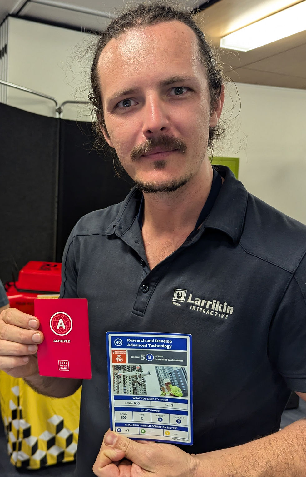 Dylan from The Array holding the completed project card.