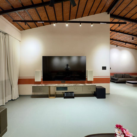 Modern living room at The Terracotta Loft with TV and wooden ceiling