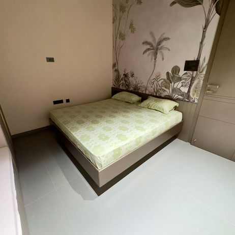 Modern bed with tropical wallpaper at The Terracotta Loft