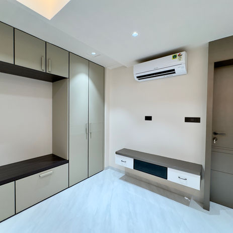 Modern bedroom with built-in wardrobes and AC unit