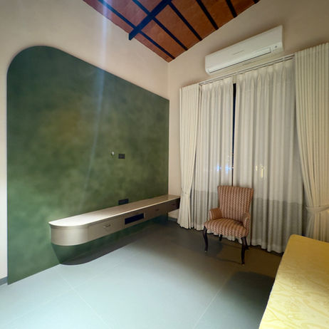 Modern interior at The Terracotta Loft with green wall.