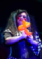 Miss Belladonna performing with a colourful balloon creation