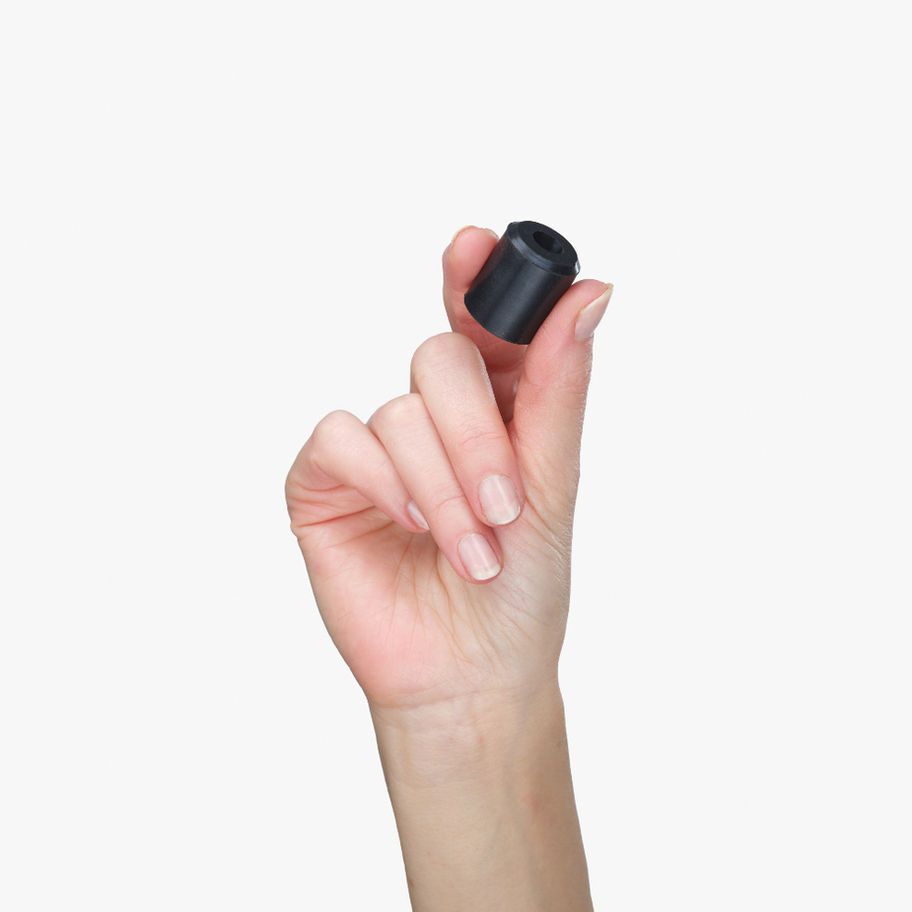 Hand holding heavy-duty vulcanized rubber ski wall mount showing durability
