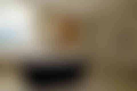 a bathroom with a black tub and a wooden door