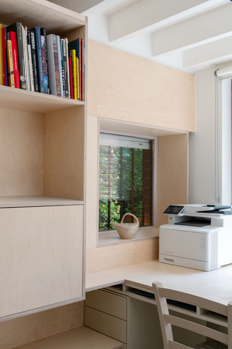 a white hp printer sits on a desk next to a window