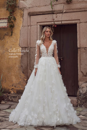 Designed with a classic ball gown silhouette, Felicity is a breathtaking backless, sparkly wedding dress that will wow everyone the moment you try her on. Designed with a glitter tulle skirt that shimmers with every step, she will ensure all eyes are on you. Her intricate lace appliqués cascade down from her side illusions and plunging V neckline to her voluminous skirt, allowing you to become the princess you were born to be. Her detachable long sleeves allow for versatile styling from ceremony to reception making her perfect for brides who seek both timeless beauty and contemporary flair.
Exclusive stockists in the North of Ireland